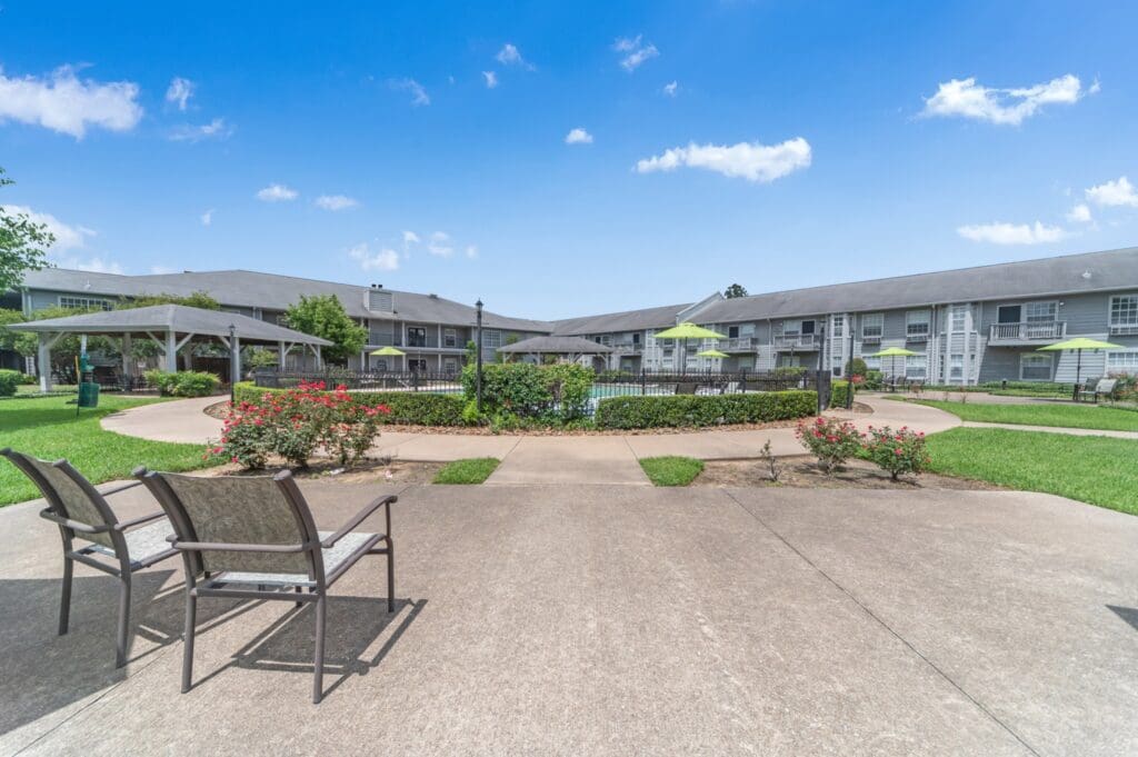 Exterior shot of Collier Park's courtyard with a gated pool area.