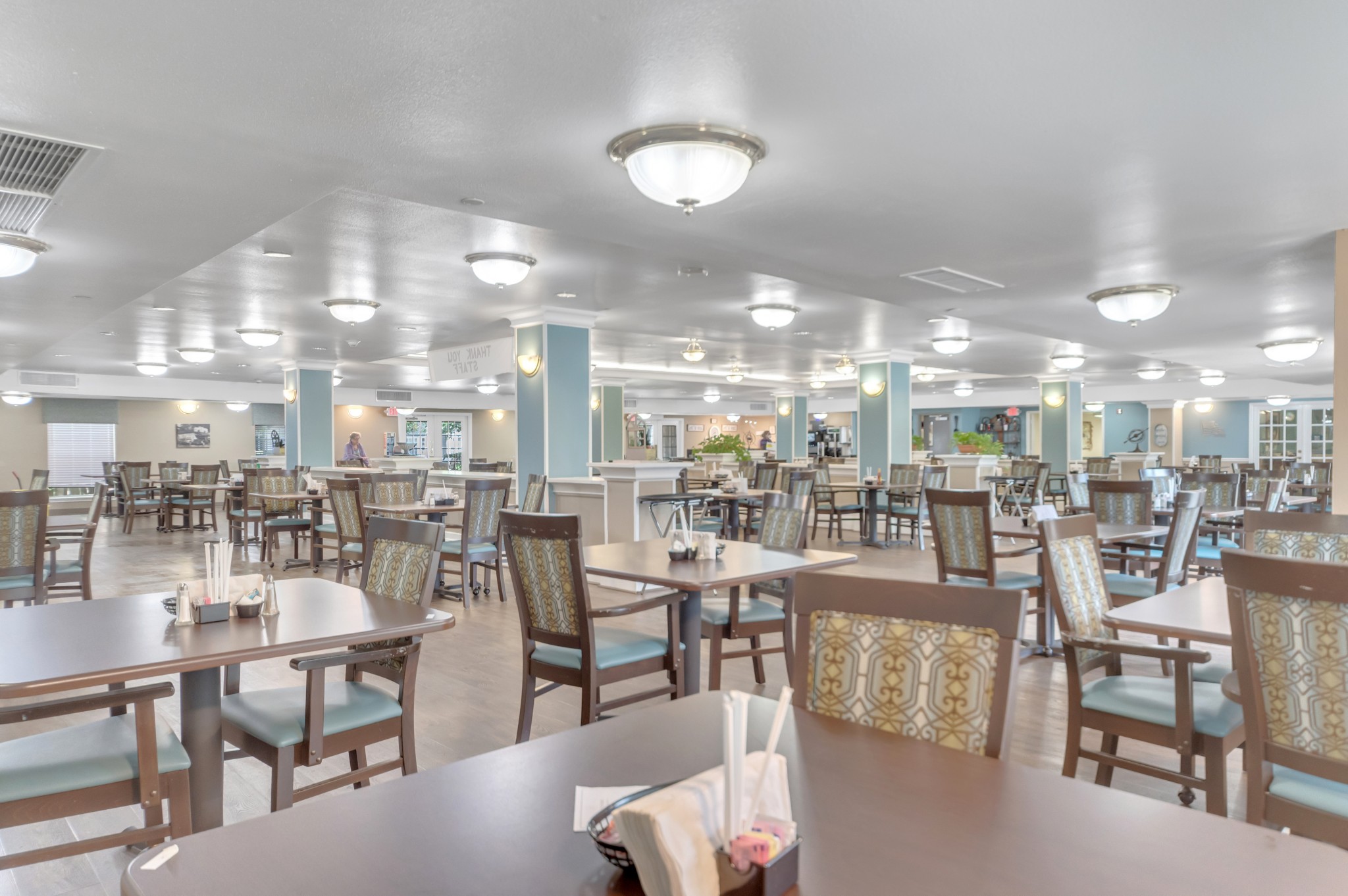 Interior shot of Collier Park's large dining room with lots of seating and tables.