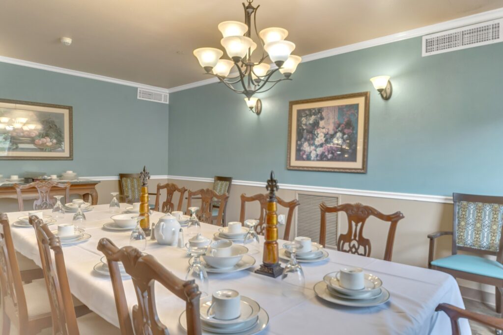 DSC_4940 - Collier Park A long, formally set dining table in the private dining room at Collier Park, a senior living community near Orange, Texas.